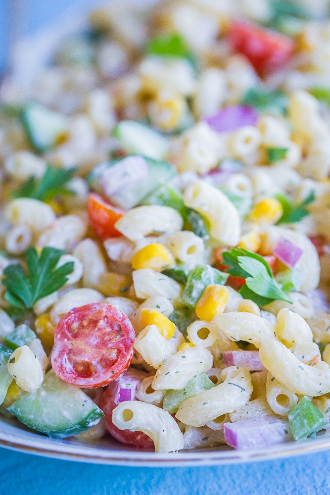 Front view of Healthier Mayo Free Macaroni Salad on a serving platter with two spoons