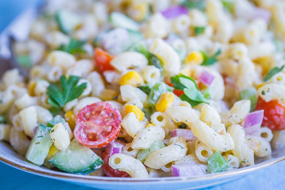 Front view of Healthier Mayo Free Macaroni Salad on a serving platter with two spoons