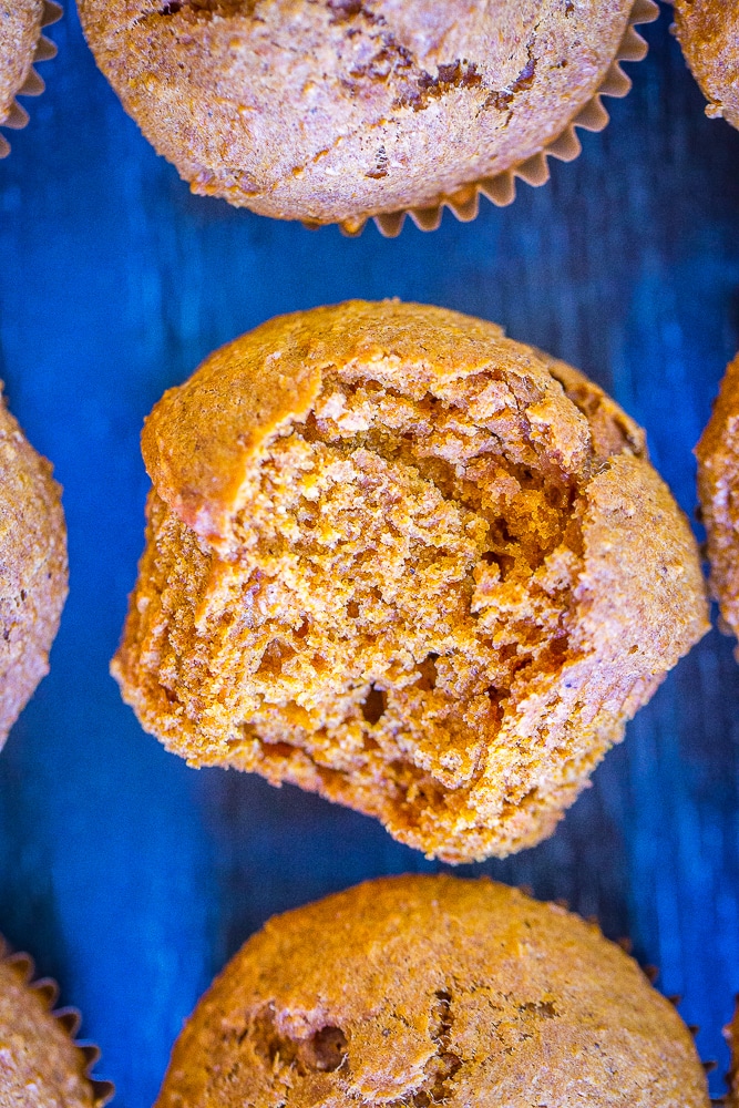 Close up of Healthy Whole Wheat Pumpkin Muffins with a bite taken out of it