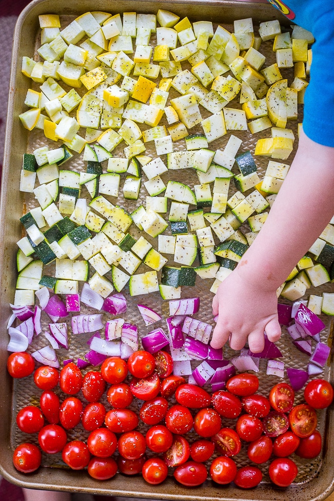 Summer vegetables on a baking sheet. Roasted Summer Vegetable Meal Prep Bowls
