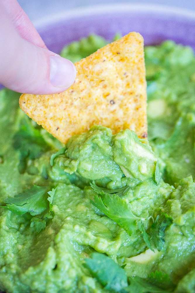 A chip dipping into The Best Easy Guacamole Recipe