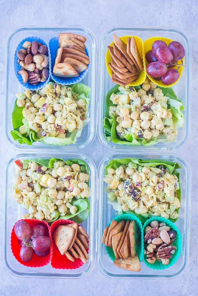 Four Curried Chickpea Salad Meal Prep Bowls next to each other.