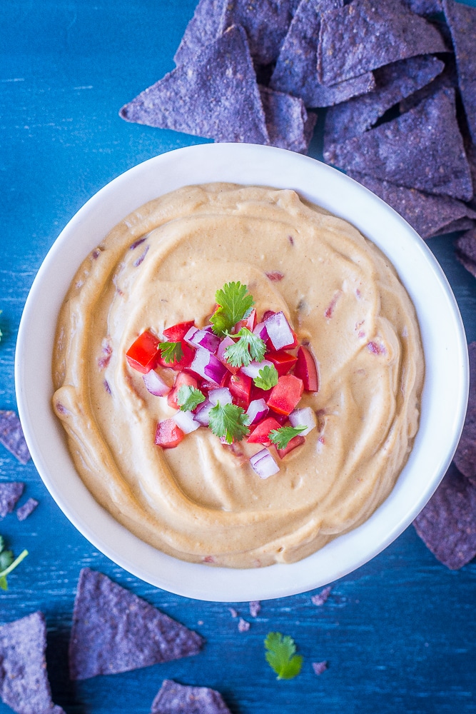 A bowl of Creamy Cauliflower Queso Dip with chips