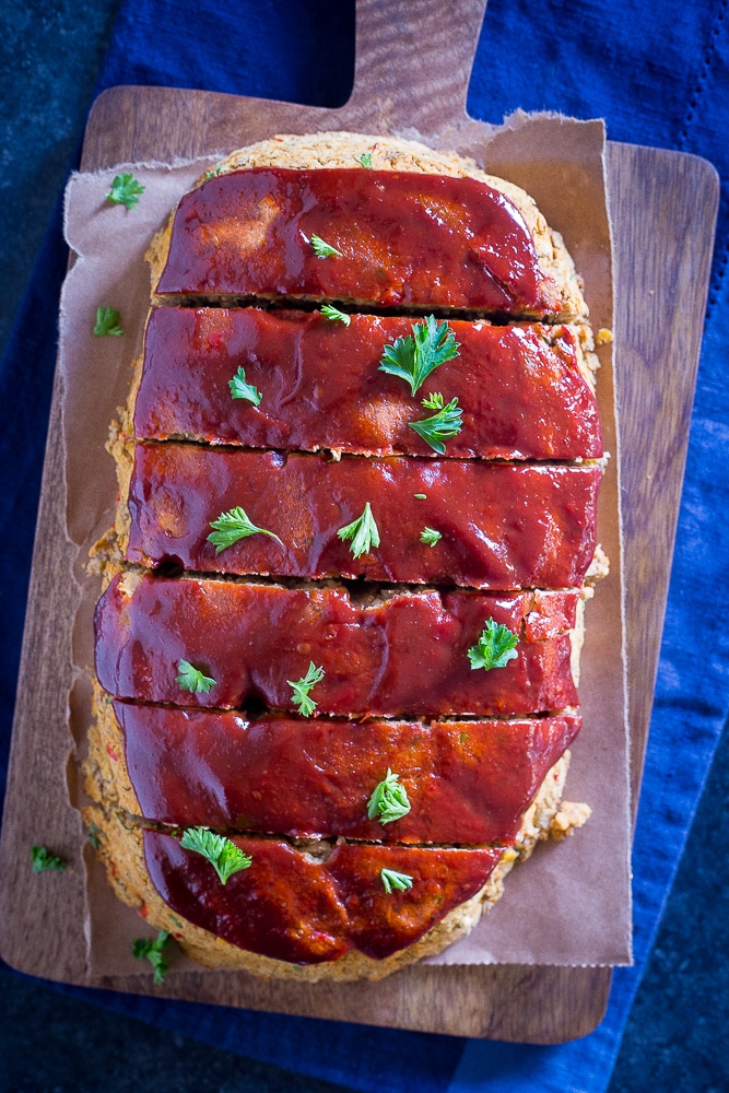 Top view of Easy Vegan Meatloaf with Lentils and Chickpeas cut into slices on a cutting board