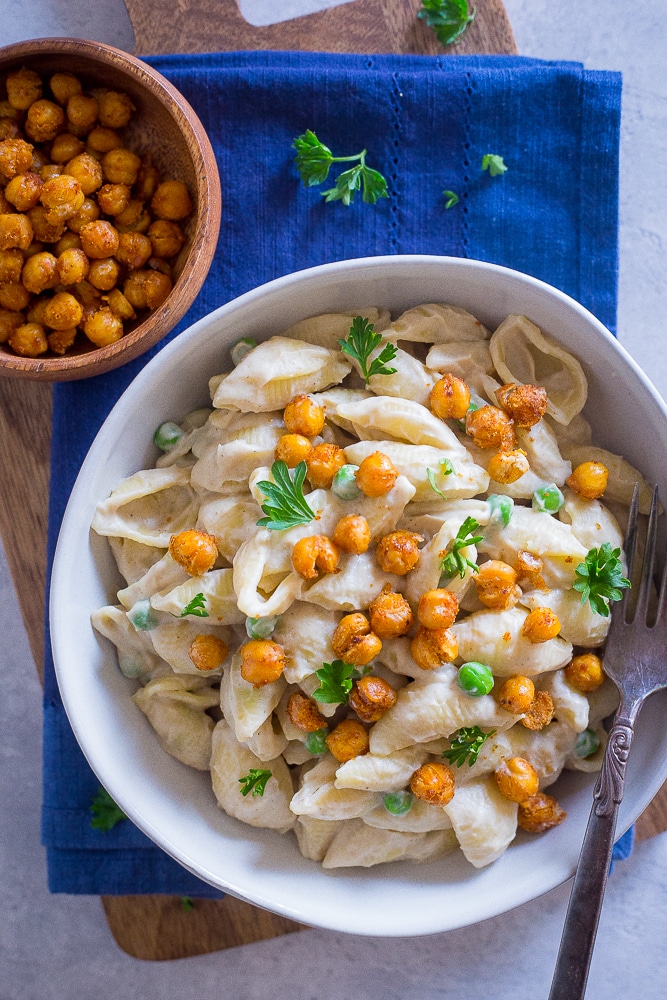 Bowl of Vegan Alfredo Pasta with Crispy Chickpeas on a blue napkin