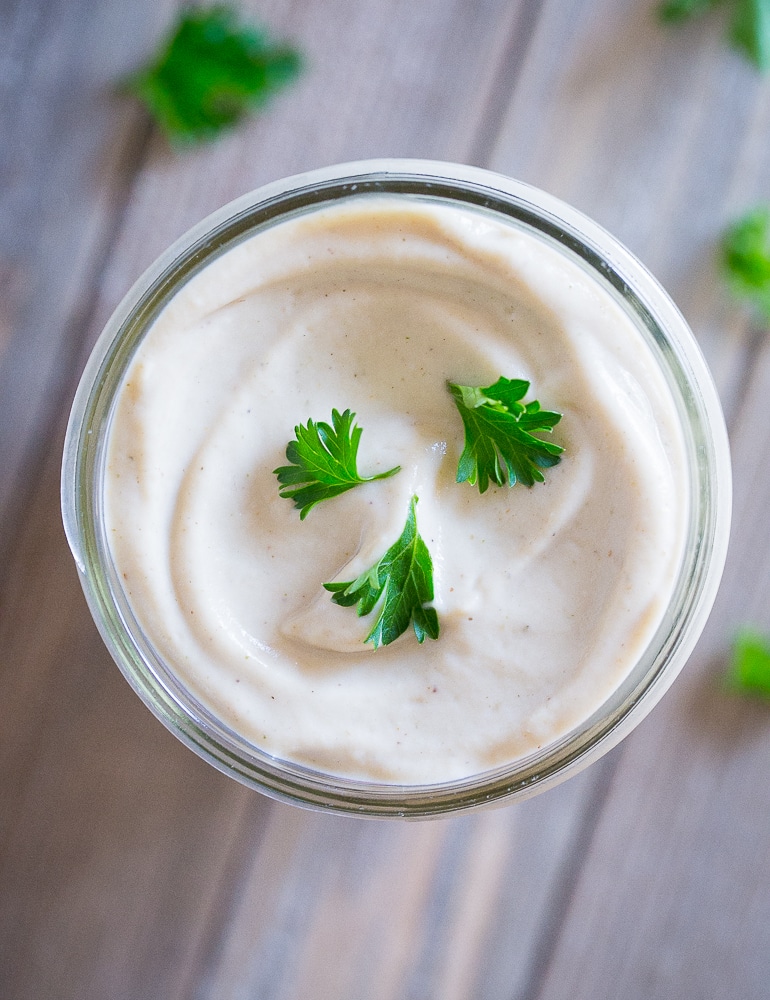 Flatlay view of Creamy Cauliflower Alfredo Sauce in a mason jar