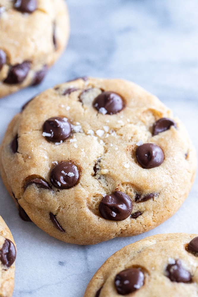 close up view of a vegan chocolate chip cookie with sea salt on top