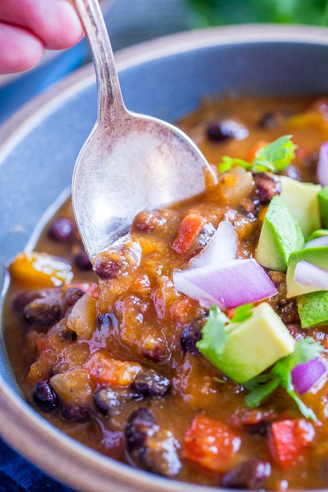 Spoon dipping into a bowl of Butternut Squash Chili with Black Beans