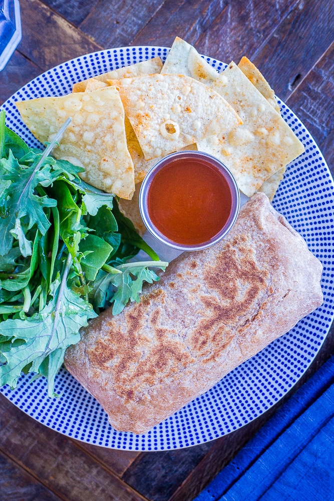 Make Ahead Bean Burritos on a plate with salad and chips