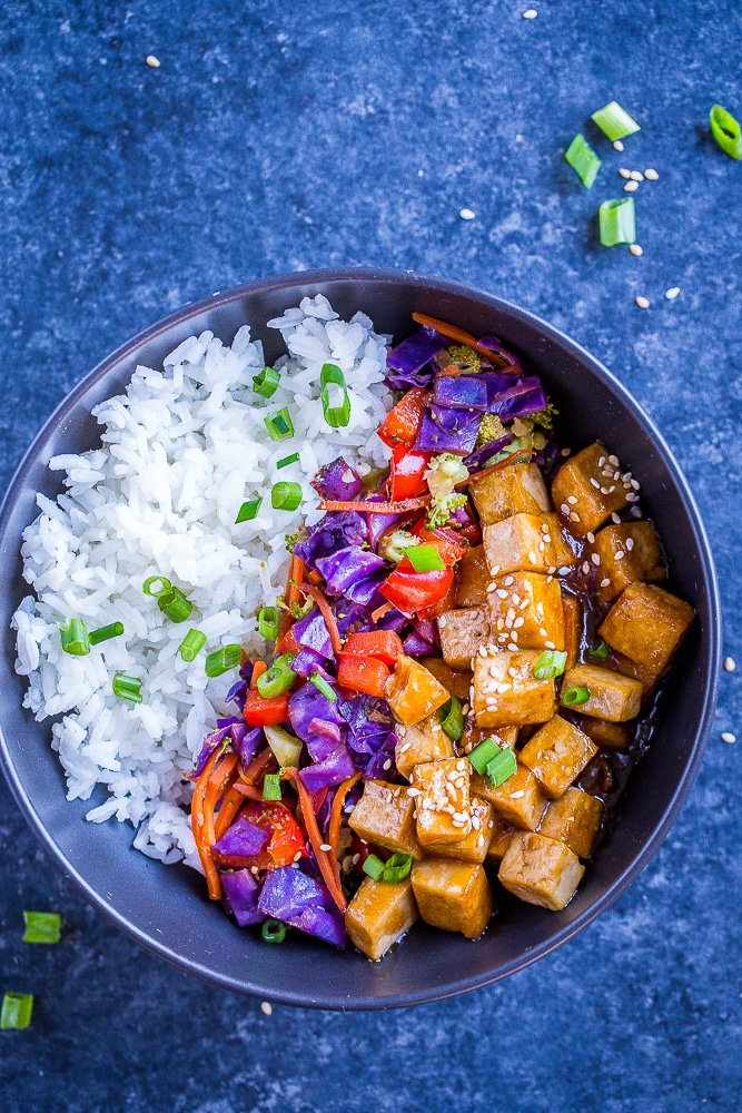 Sesame Ginger Tofu Meal Prep Bowls on a black background