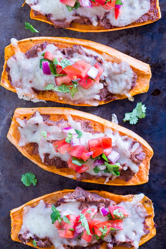 Sweet Potato Tostadas on a baking sheet with toppings