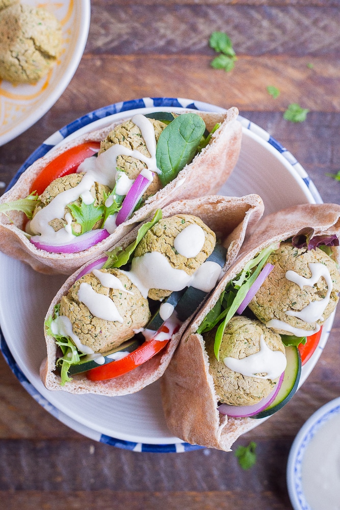 Easy Homemade Falafel stuffed into pitas with sauce and vegetables