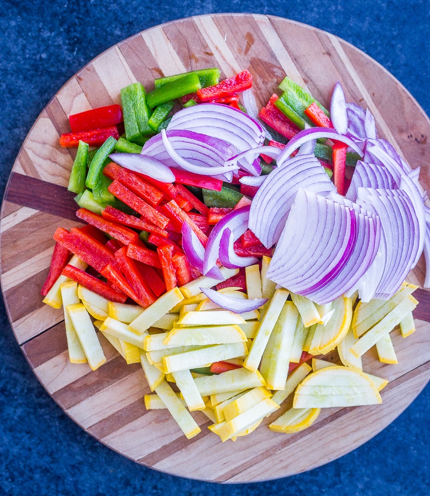 Vegetables cut up on a cutting board for fajita tostadas