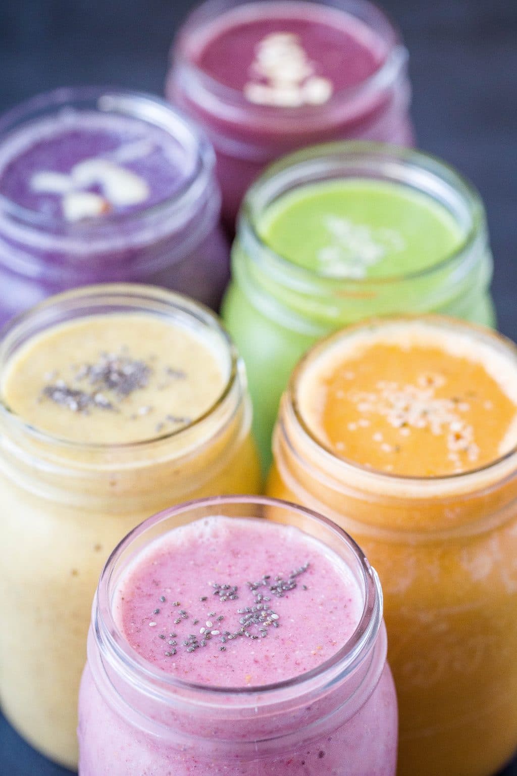 six healthy smoothie recipes in glass jars
