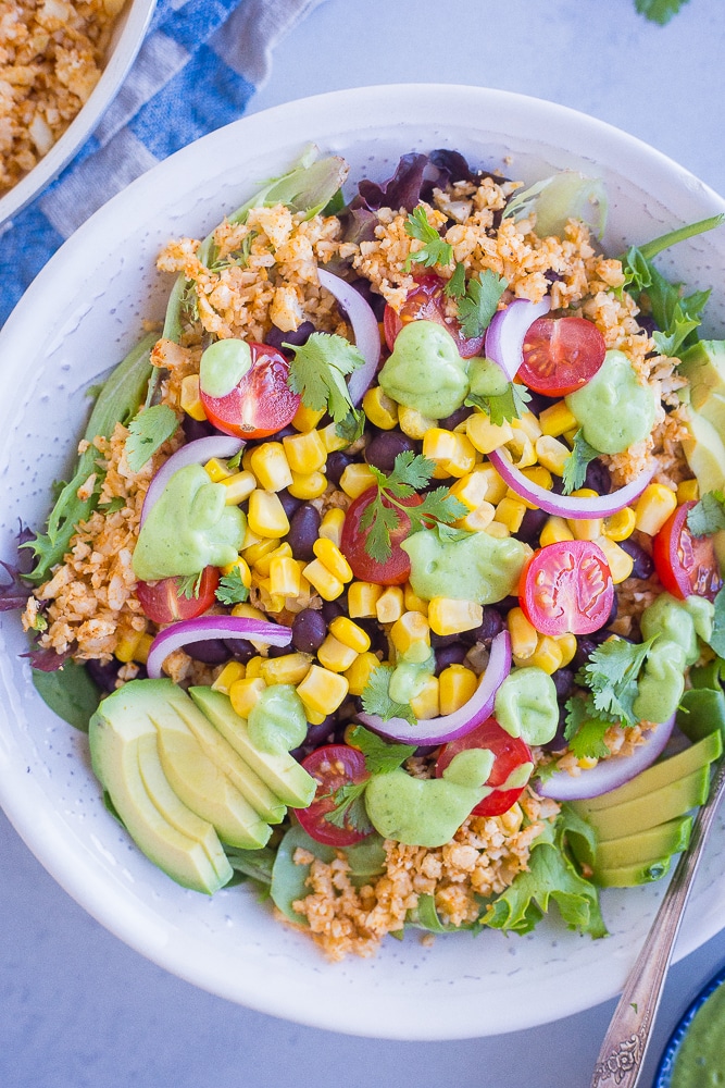 Avocado ranch dressing on top of a burrito bowl