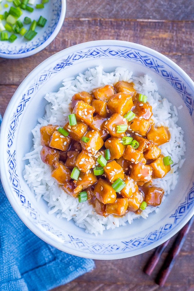 Vegan orange tofu onto of rice in a bowl