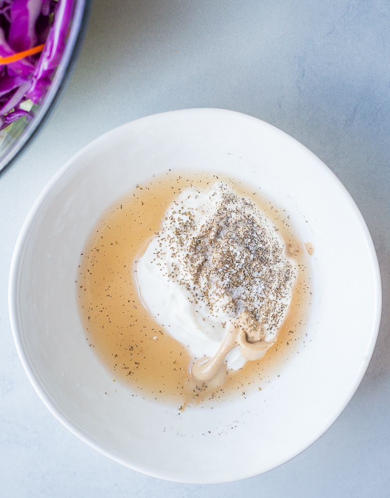 Dressing ingredients in a bowl for easy homemade coleslaw