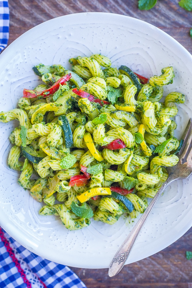 Large bowl of pesto pasta with summer vegetables