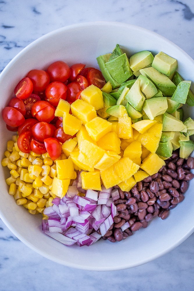 Ingredients in a bowl to make Black Bean Salad with Mango and Avocado