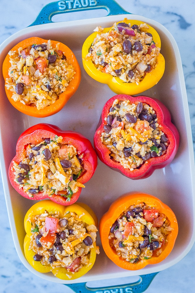 Vegetarian stuffed peppers in a pan about to go in the oven