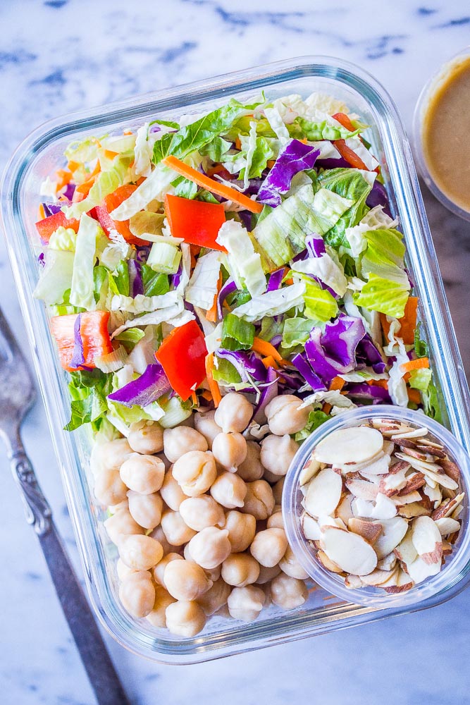 Asian Chopped Salad in a meal prep container with chickpeas and almonds