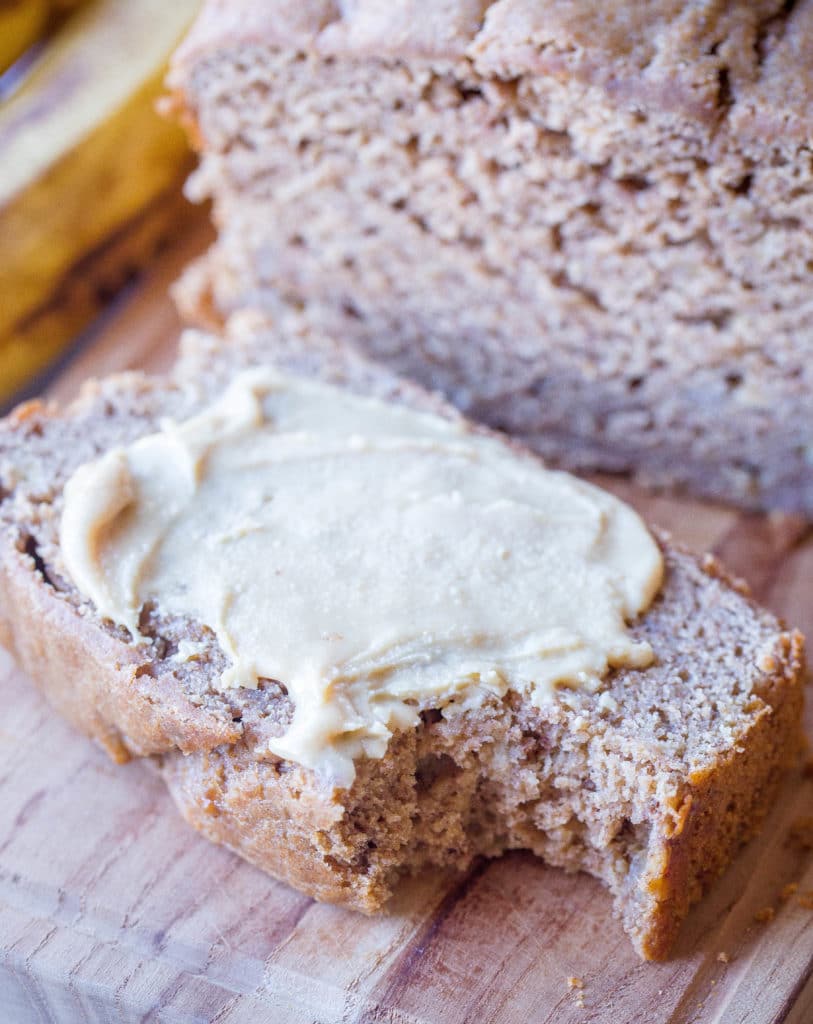 Slice of healthy banana bread with peanut butter on it