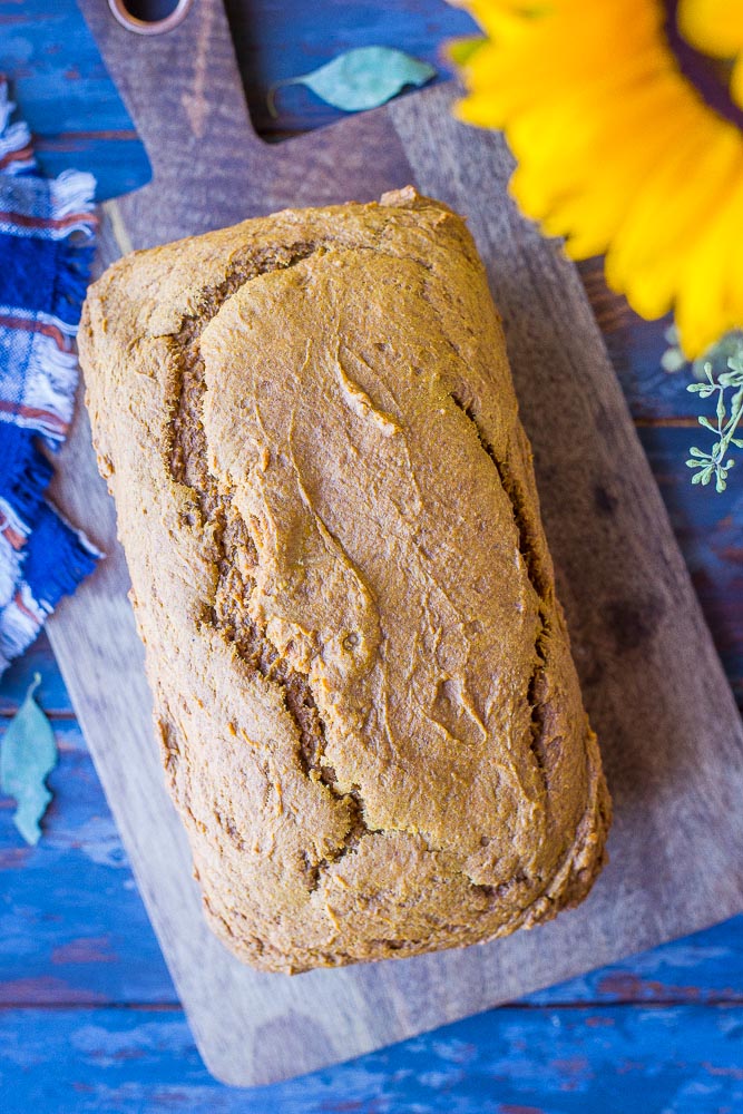 a loaf of healthy pumpkin bread on a cutting board