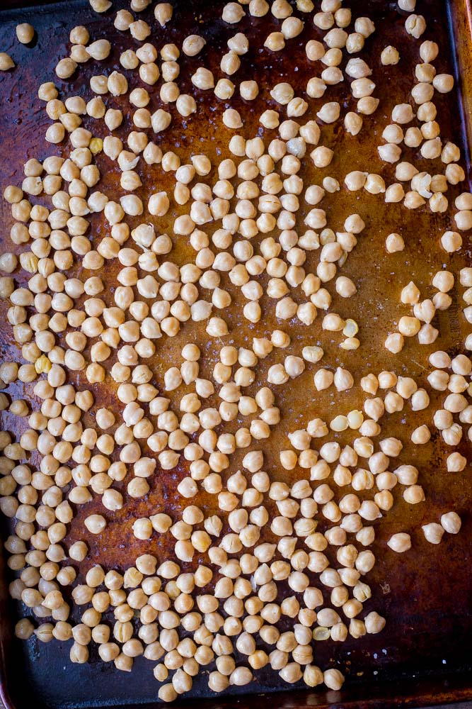 Chickpeas on a sheet pan ready to go into the oven for salt and vinegar roasted chickpeas