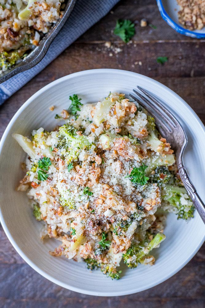 bowl of broccoli cheese casserole with a fork