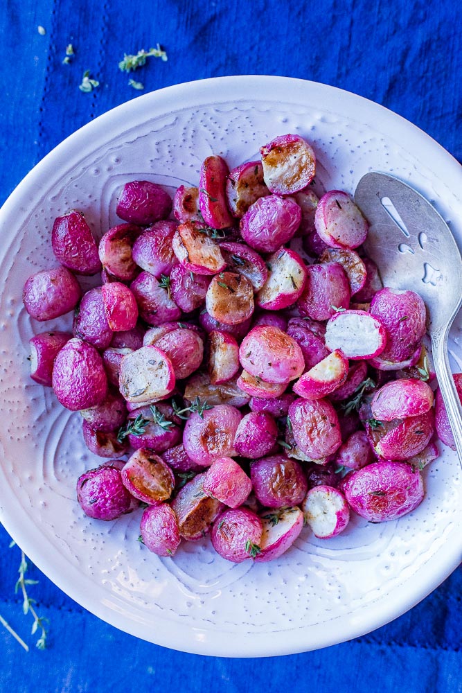 Roasted Radishes in a bowl on a blue napkin