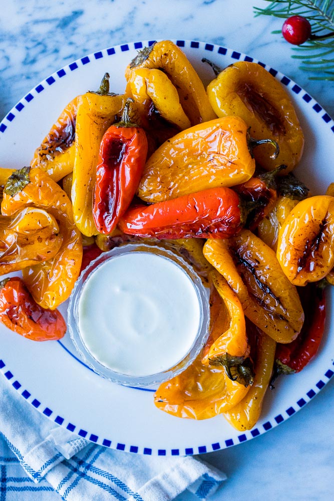 Close up of a plate of roasted sweet peppers with goat cheese sauce
