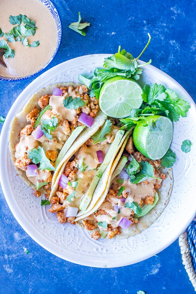 A bowl of vegan tacos with tahini cheese sauce