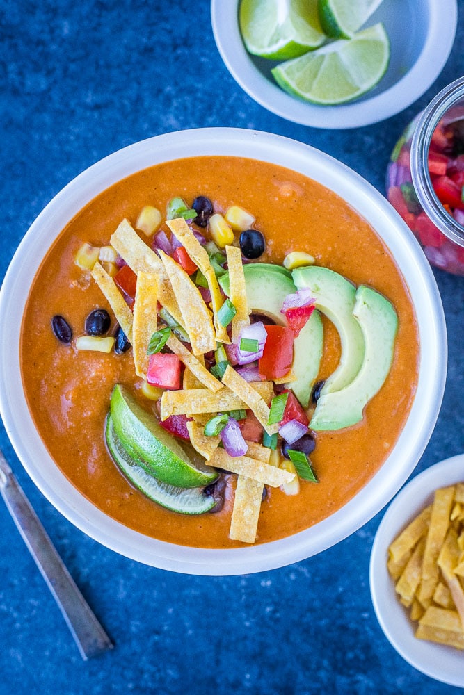 Bowl of vegetarian tortilla soup with toppings