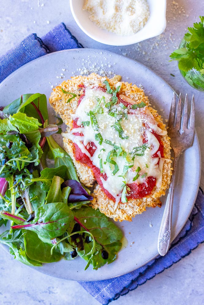 A plate with cauliflower parmesan and salad