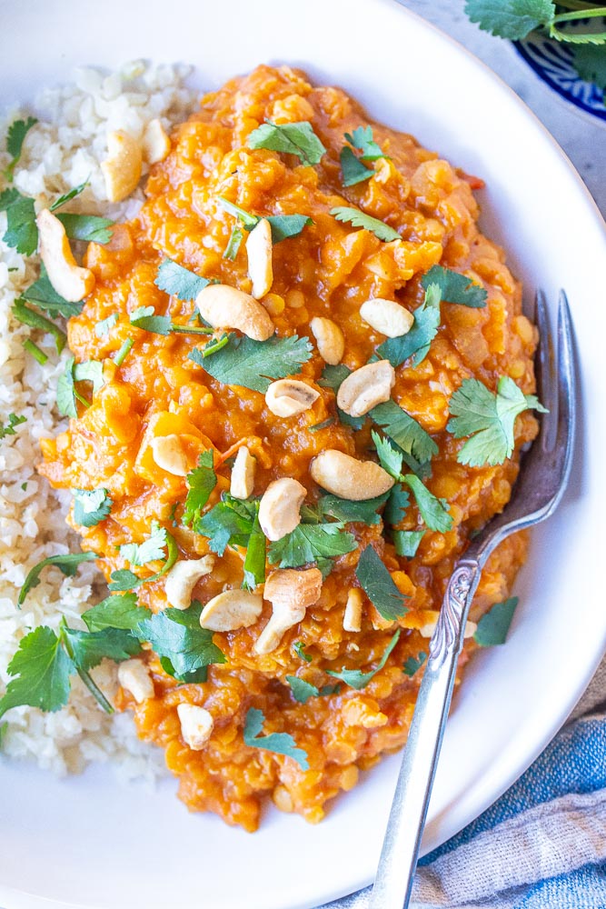 Close up photo of red lentil curry in a bowl