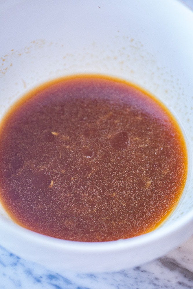 showing how to make sesame noodles with a bowl of sauce