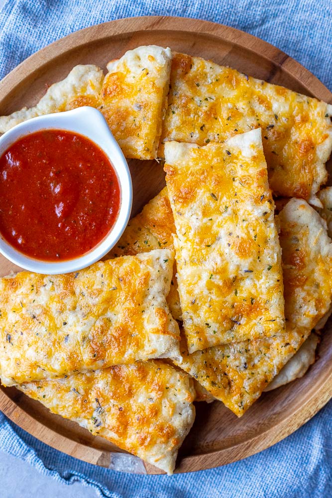 A plate of cut up garlic cheese bread