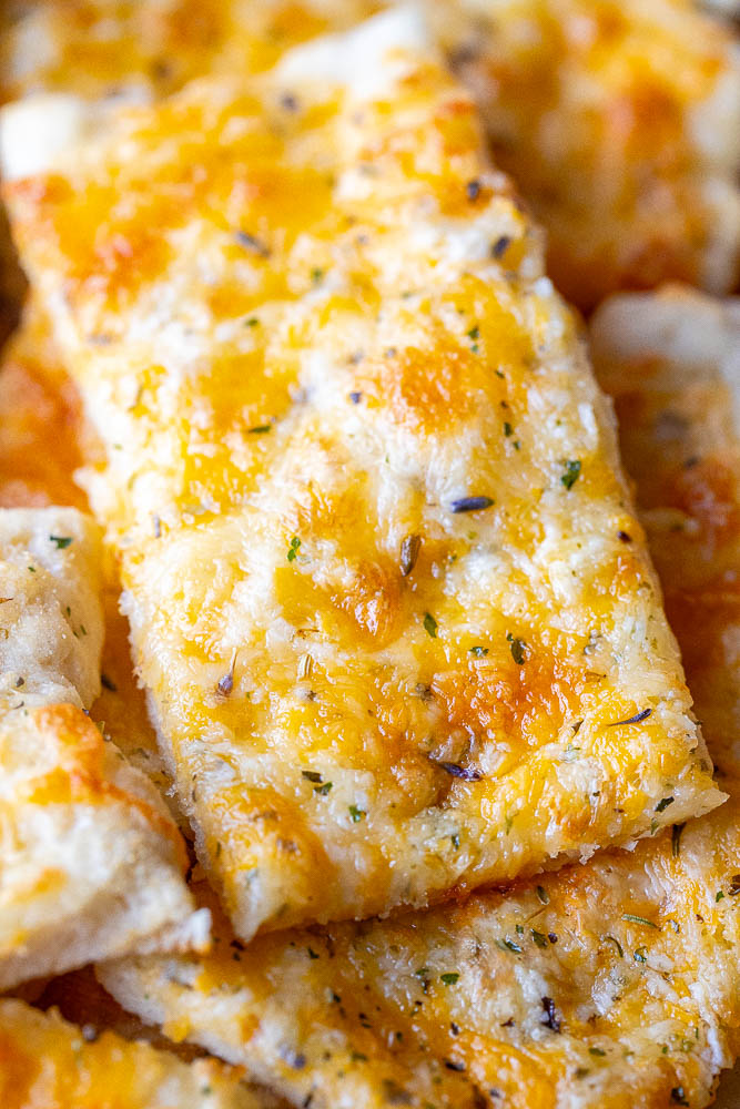 Close up of a stick of garlic cheese bread