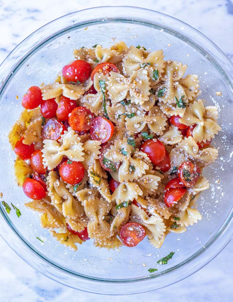 Bruschetta pasta salad in a mixing bowl