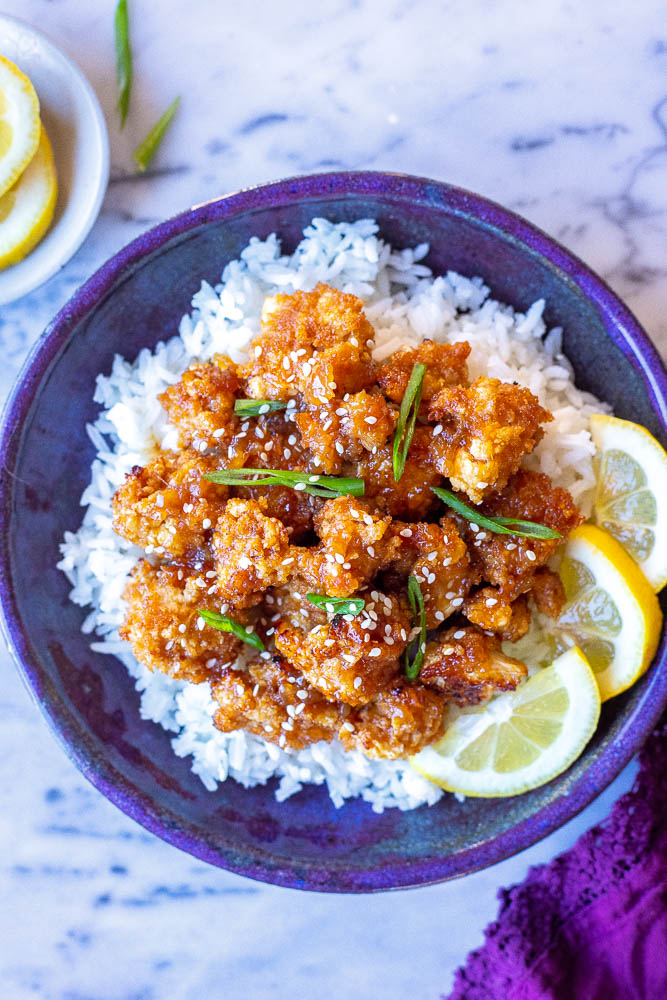 A bowl of sticky lemon cauliflower over rice