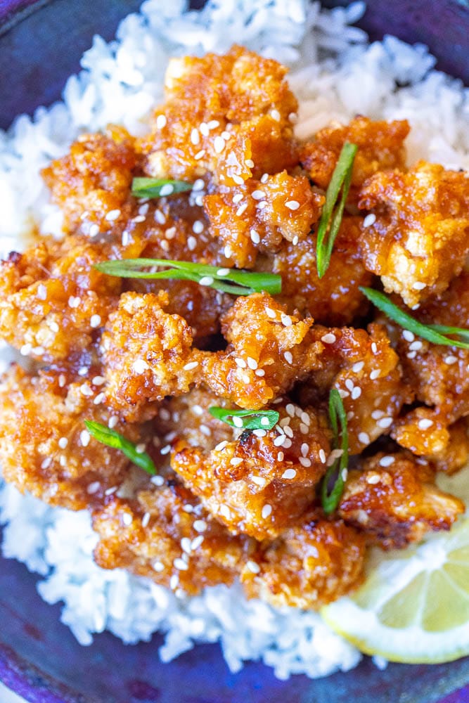 close up photo of a bowl of sticky lemon cauliflower