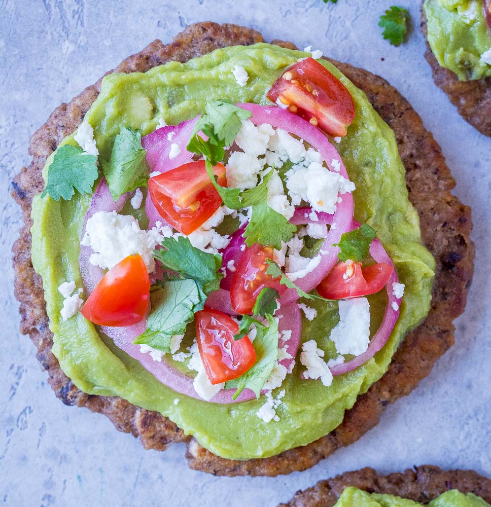 Close up of a guacamole tostada with toppings