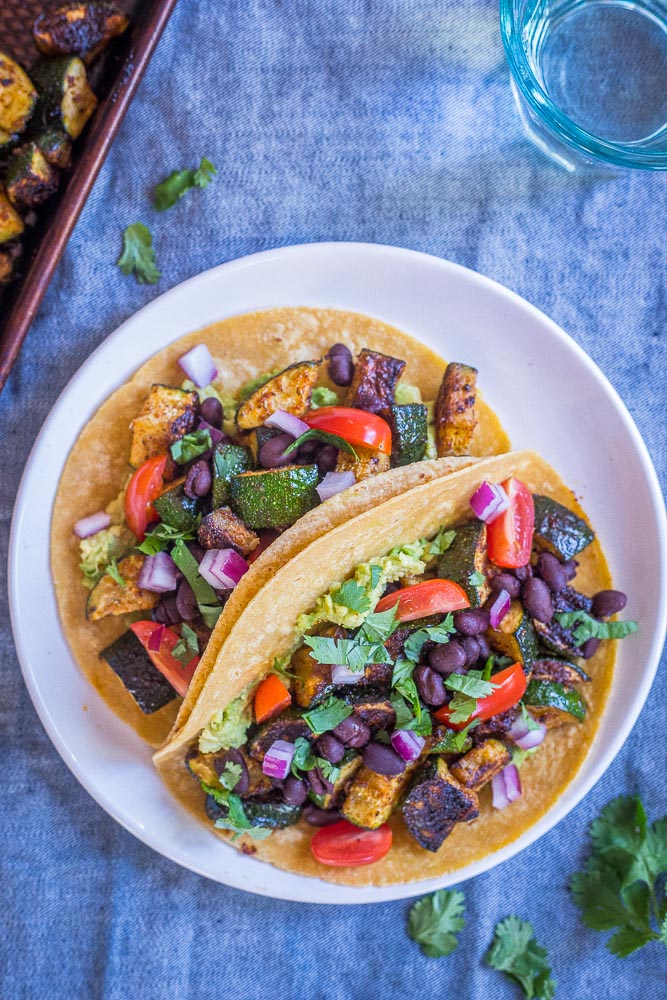 zoomed out shot of these roasted zucchini tacos on a plate