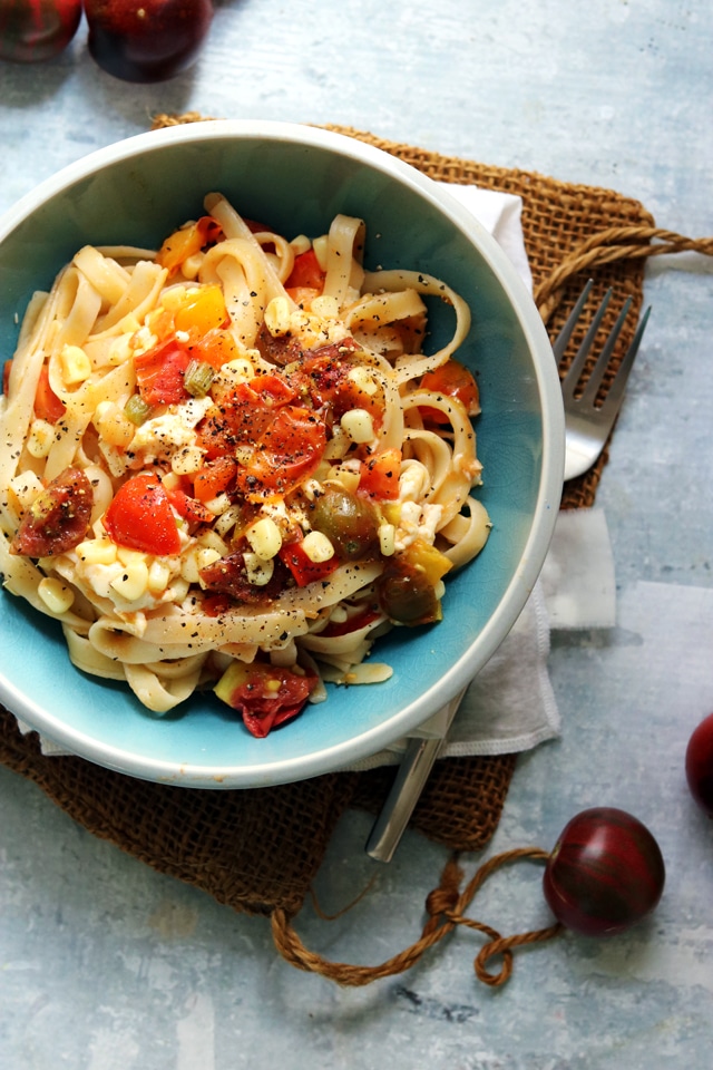 A bowl of food on a plate, with Pasta and Fettuccine