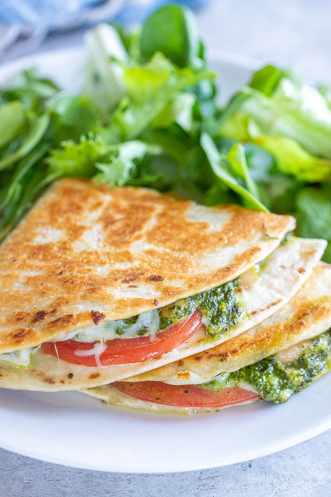 Close up of pesto quesadillas on a plate with salad