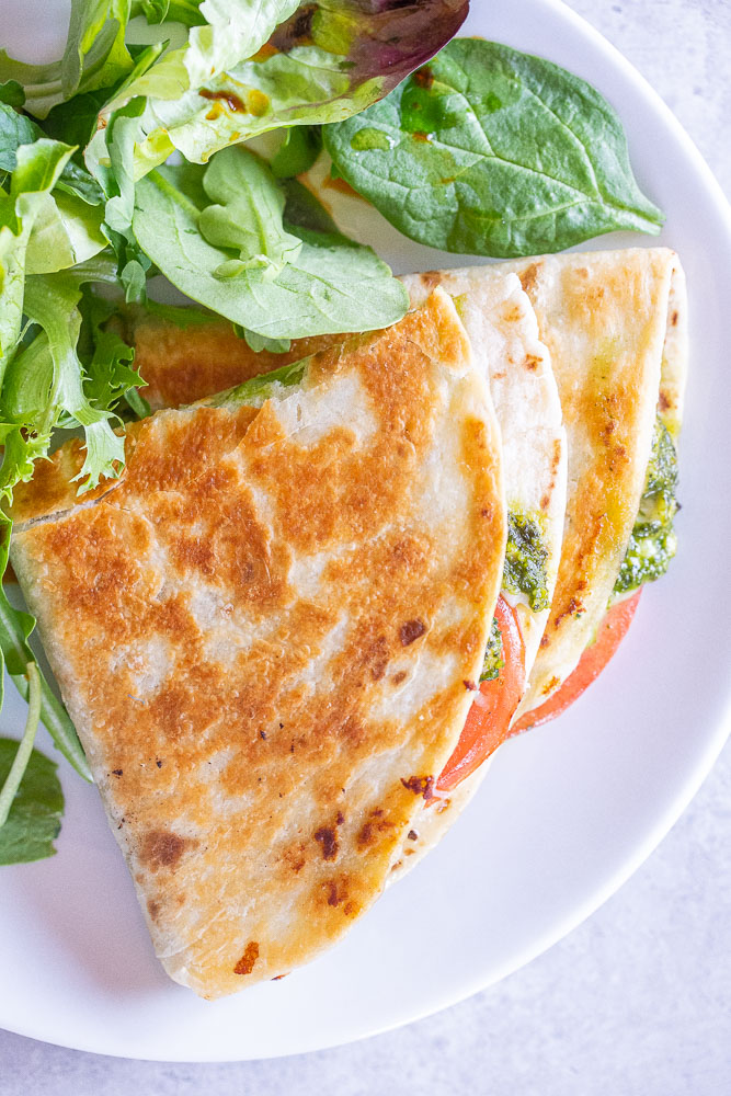 overhead shot of quesadillas on a plate with salad