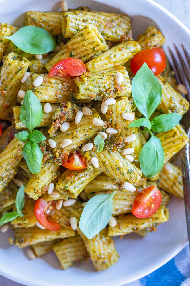 Close up of a bowl of pesto pasta