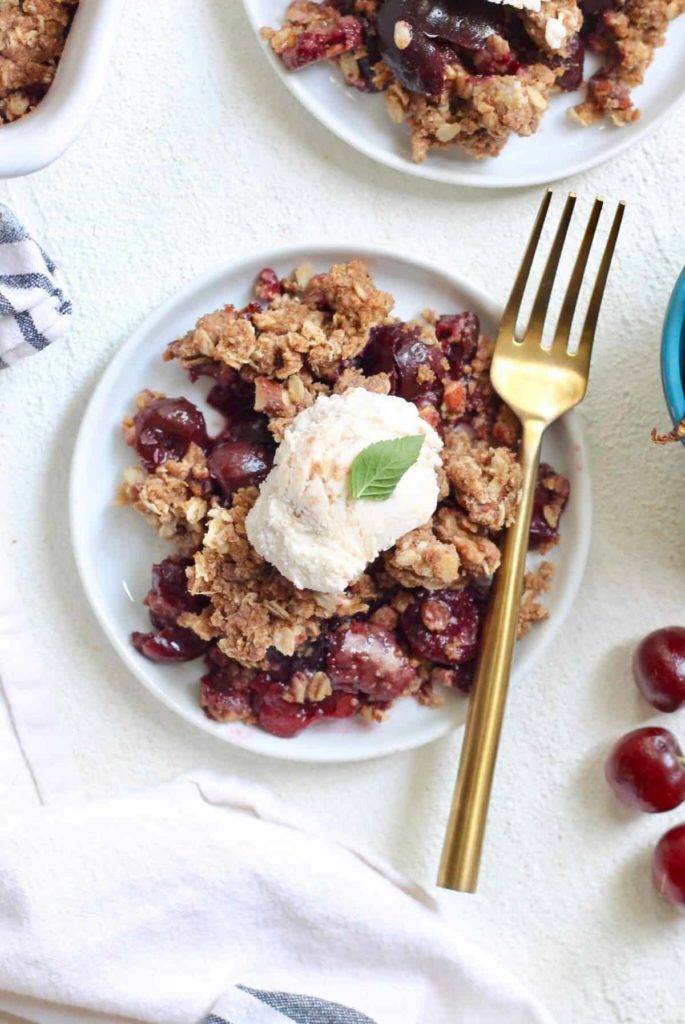 A piece of cake on a plate, with Crisp and Cherry