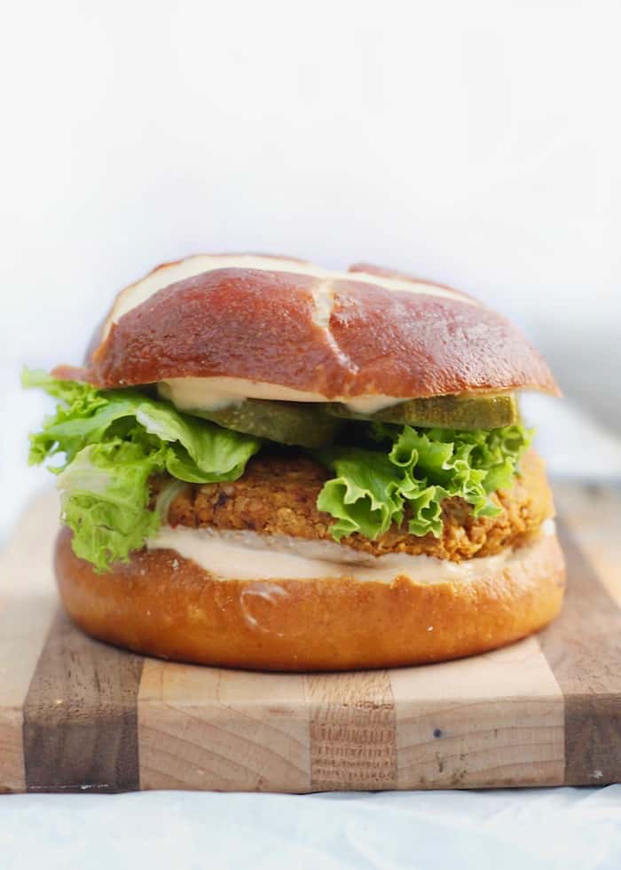 A sandwich sitting on top of a wooden cutting board