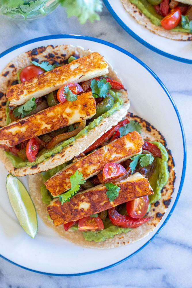 A plate with two vegetarian fajitas on it